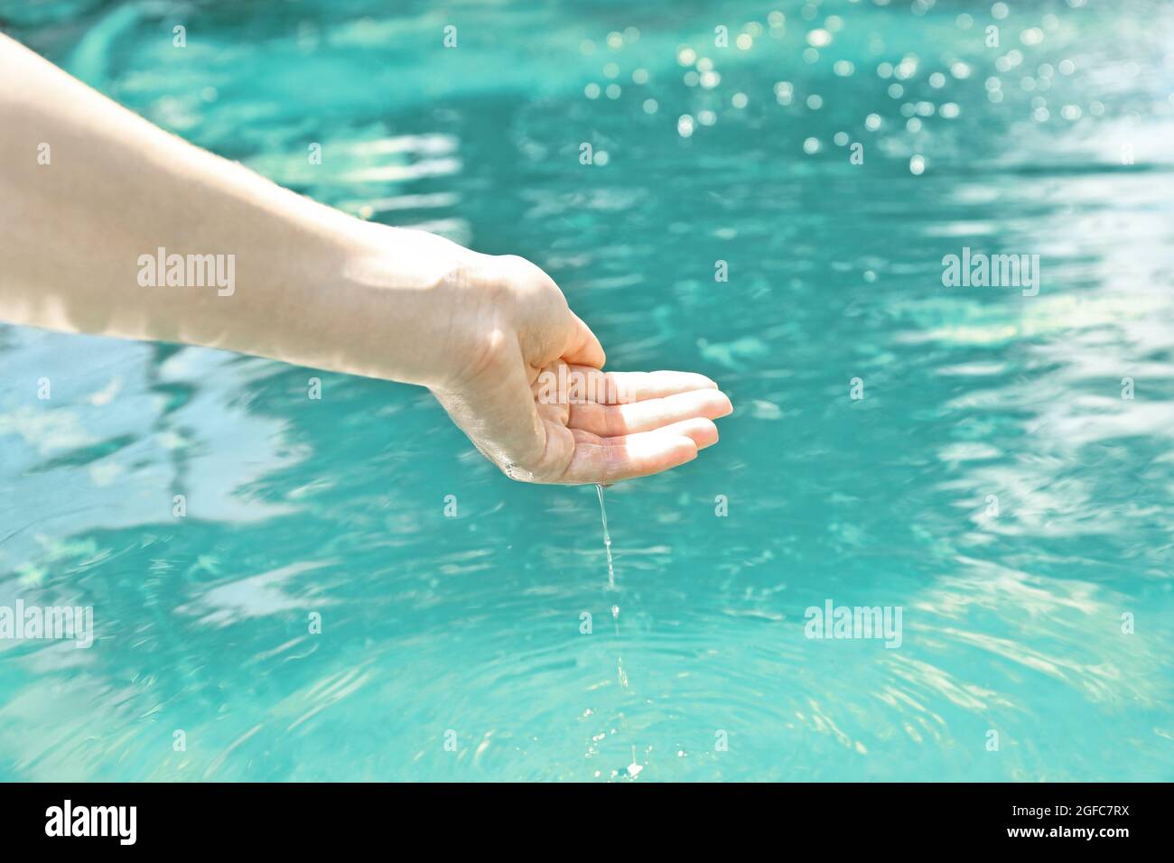 Water dripping from female hand to garden pond Stock Photo Alamy