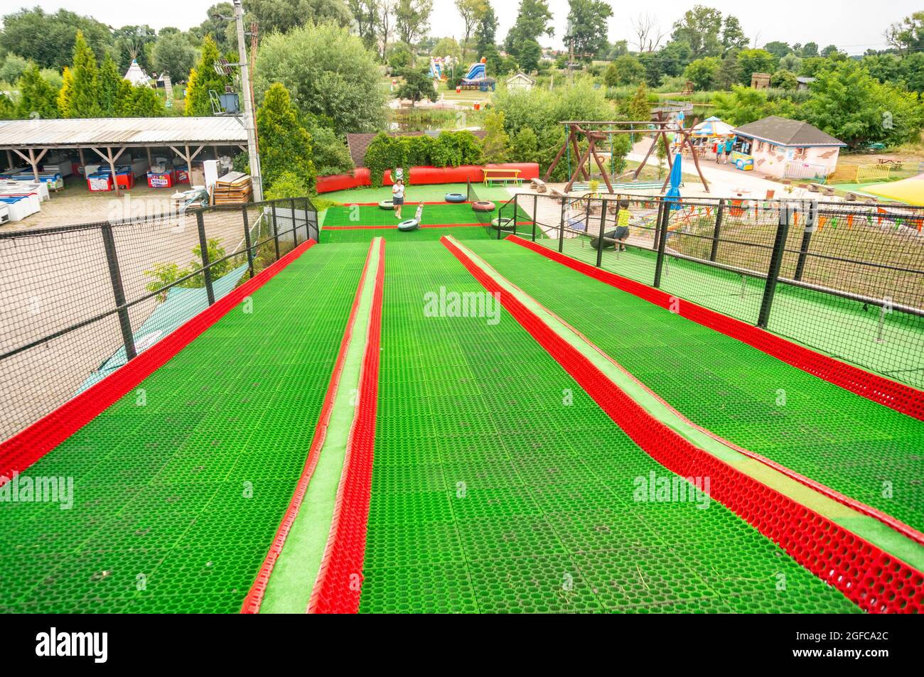 KOSCIAN, POLAND - Aug 01, 2021: A green and red slide track at the Nenufar  Club entertainment park in Koscian, Poland Stock Photo - Alamy