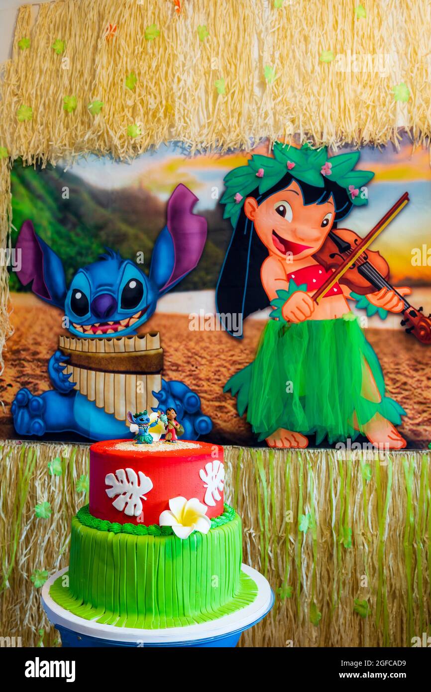 New York, USA - June 25, 2021: View of Birthday Party with Stitch and Lilo Theme in Background and Cake in Foreground. Stock Photo