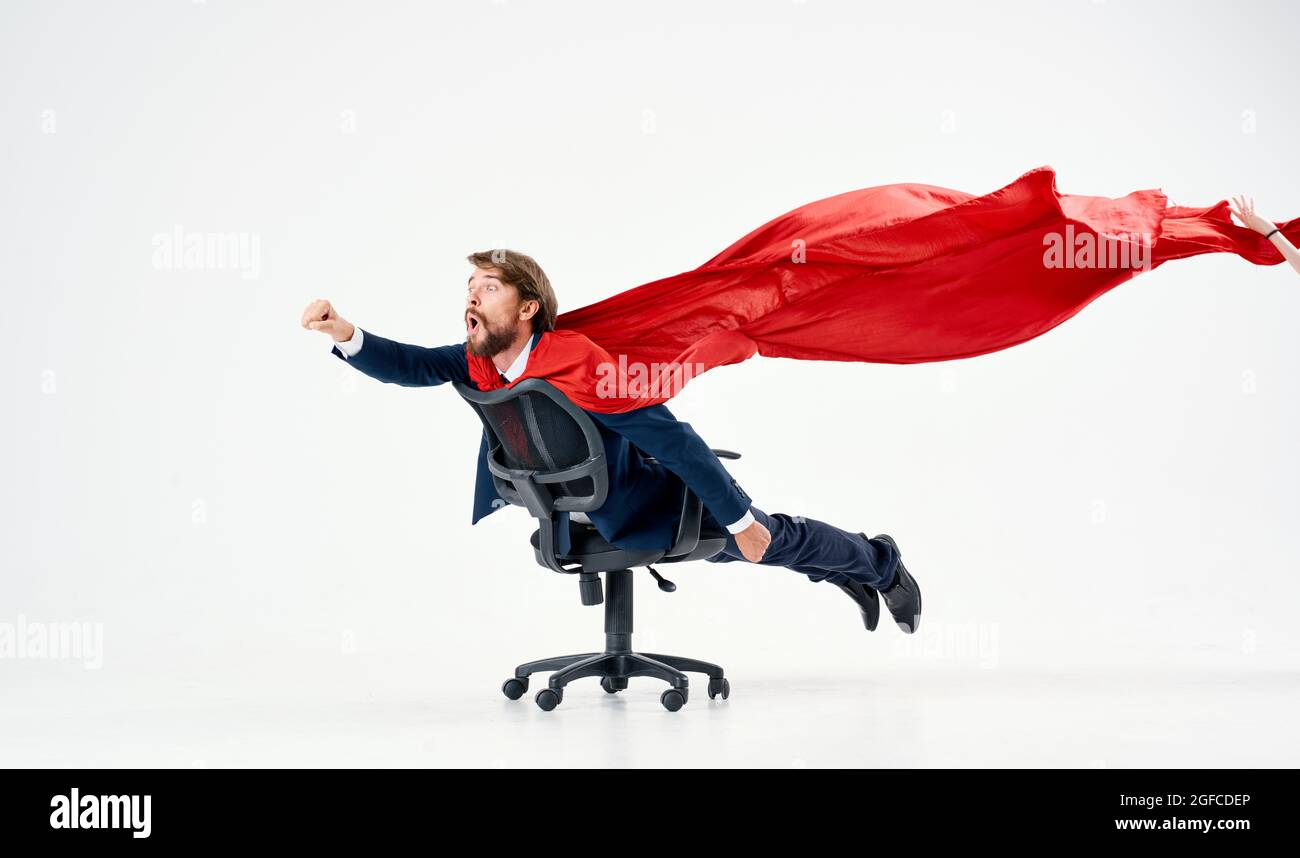 business man with red cloak trying in superman office chair Stock Photo ...