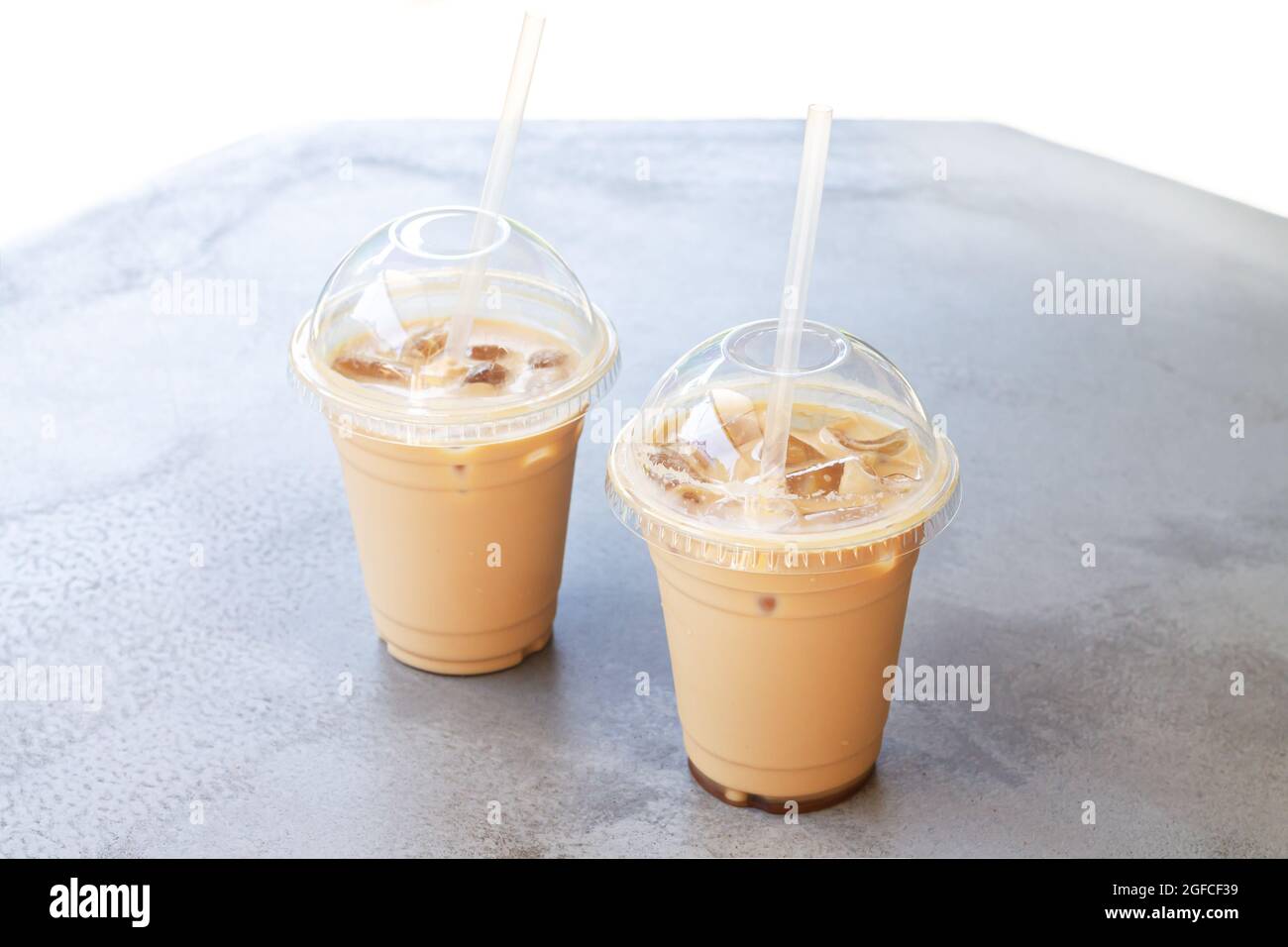 https://c8.alamy.com/comp/2GFCF39/two-iced-coffee-or-latte-in-take-away-plastic-cup-on-street-cafe-stone-table-2GFCF39.jpg