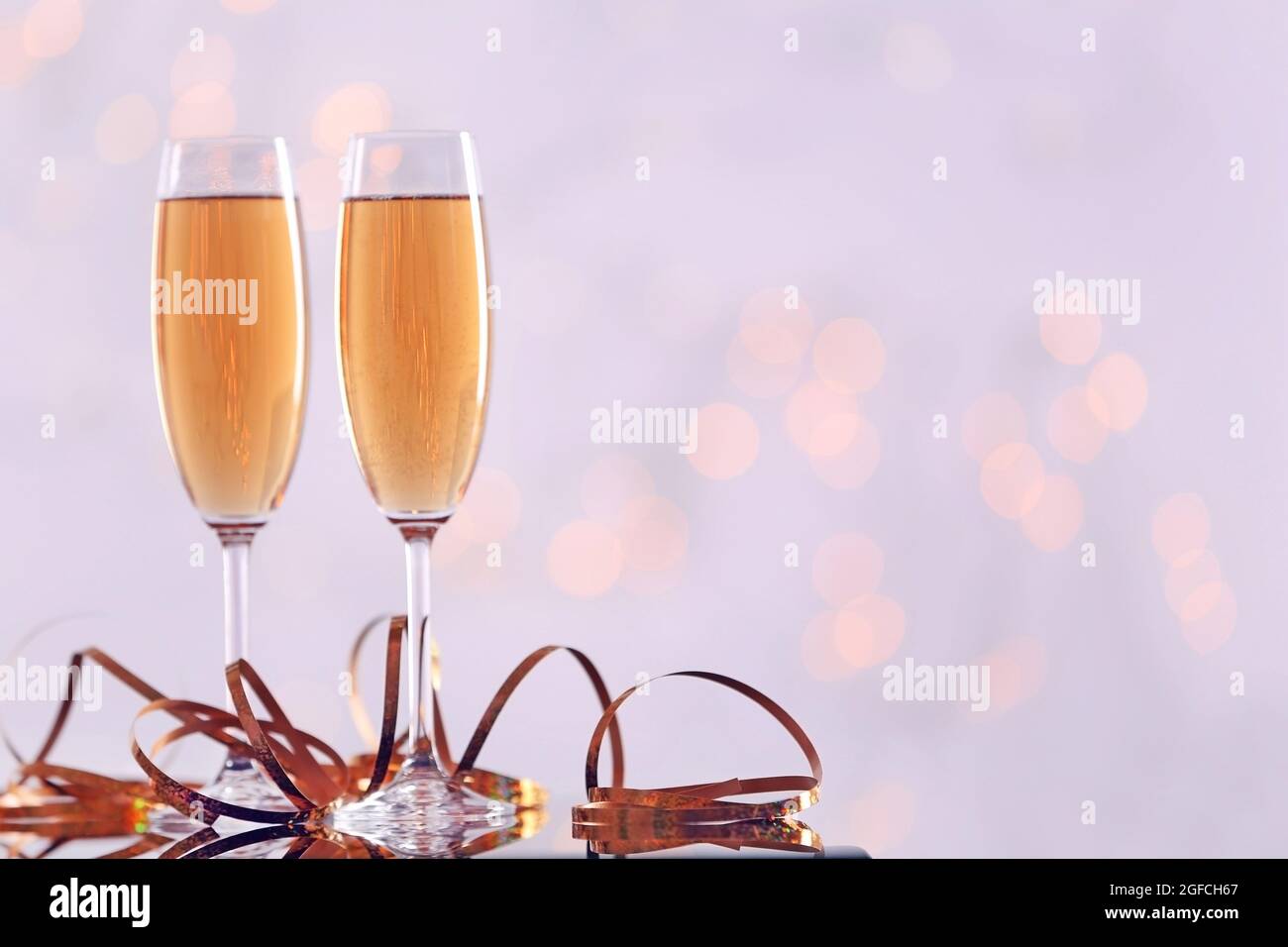 Two champagne glasses with ribbon on light background Stock Photo - Alamy