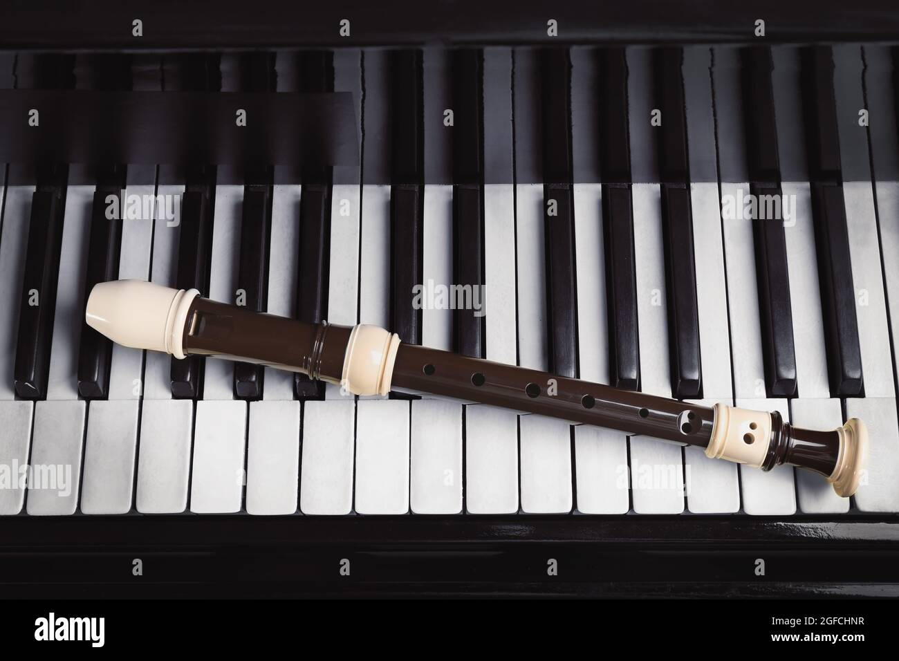 Flute on piano keys, closeup Stock Photo Alamy
