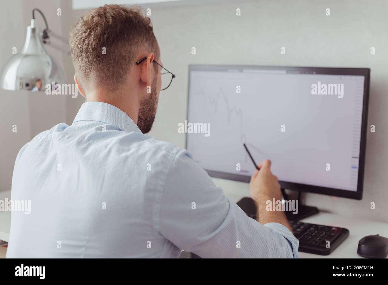 businessman looking on stock chart on screen Stock Photo
