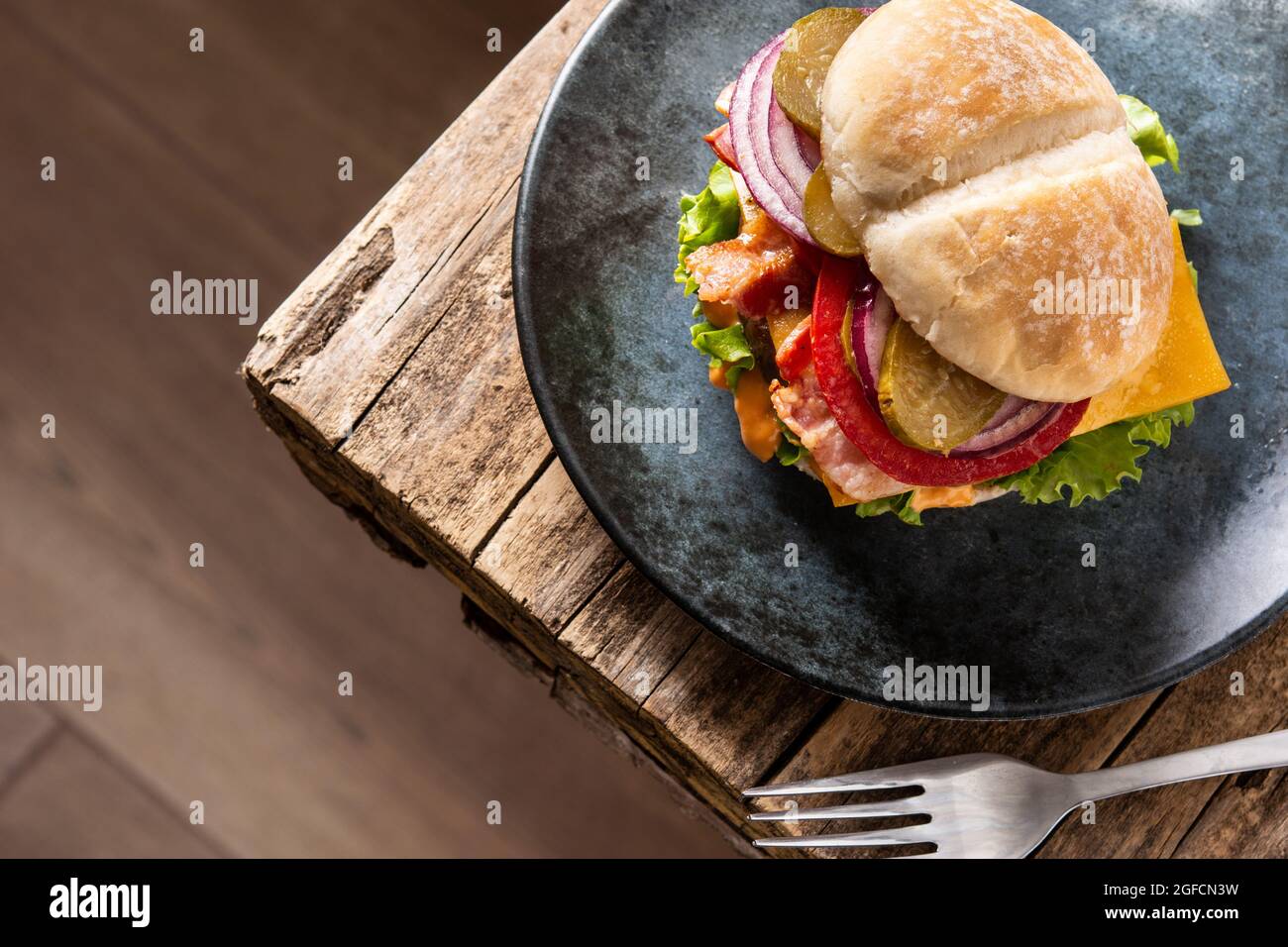 Beef burger with cheese and bacon on rustic wooden table Stock Photo