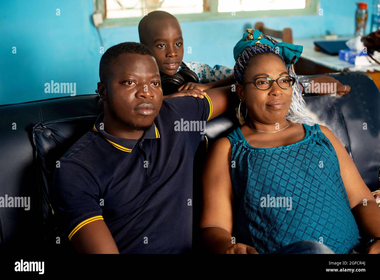 portrait of a beautiful happy African family sitting on the couch and ...