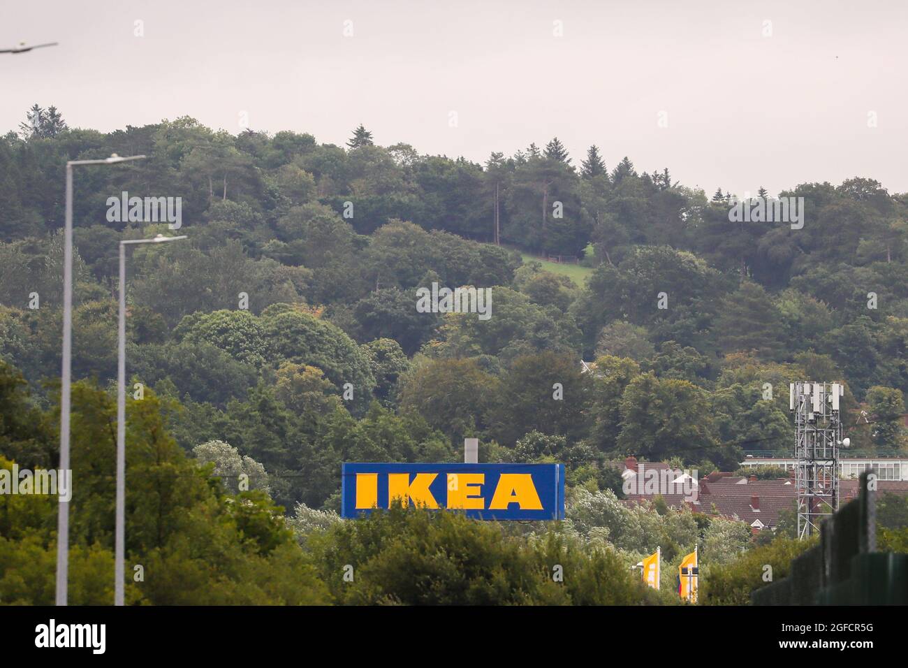 The Ikea logo and signage surrounded by trees their outlet and shop in