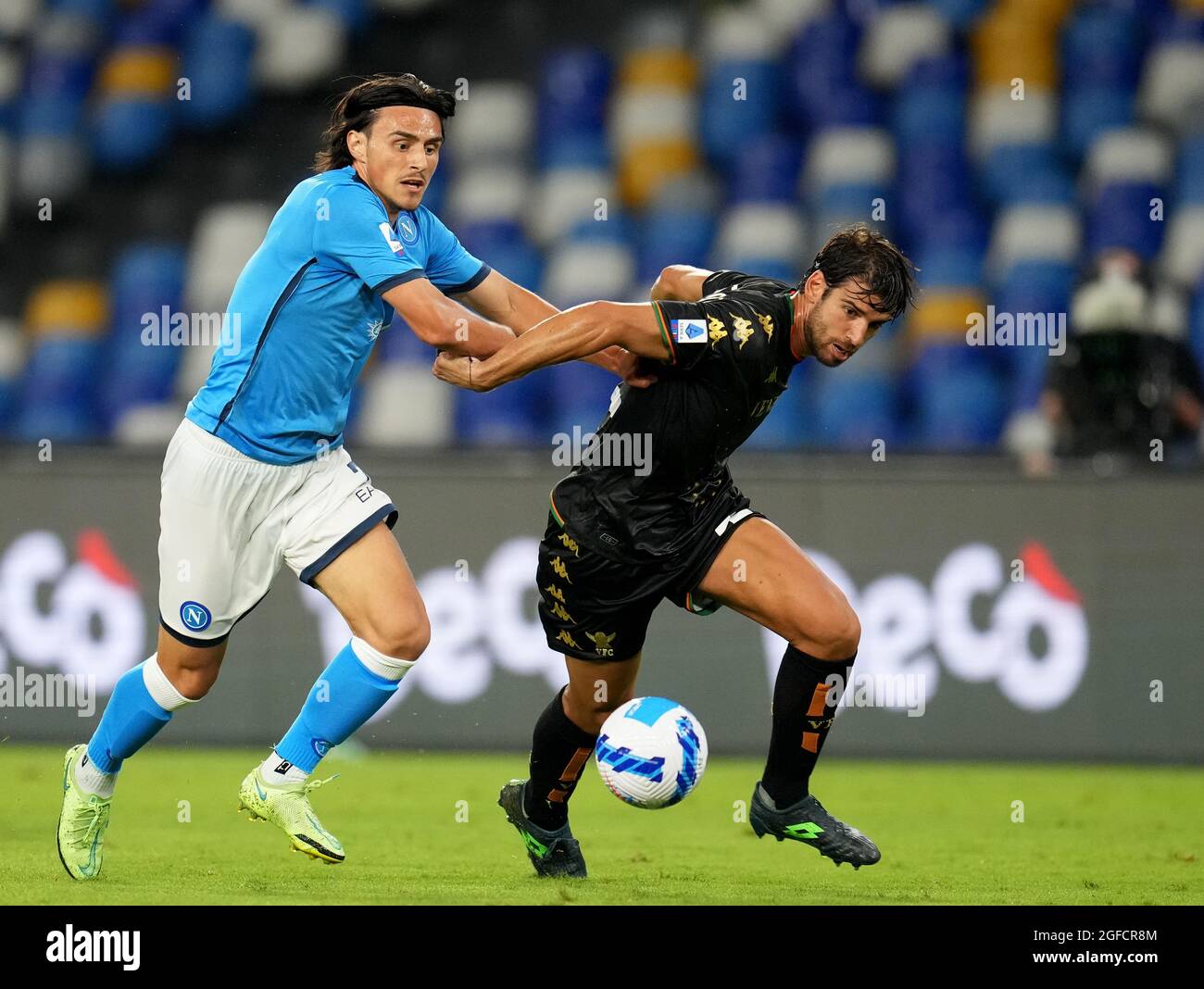 NAPLES, ITALY - AUGUST 22: Elif Elmas of SSC Napoli competes for the ball with Pietro Ceccaroni of Venezia FC ,during the Serie A match between SSC Napoli v Venezia FC at Stadio Diego Armando Maradona on August 22, 2021 in Naples, Italy. (MB Media) Stock Photo