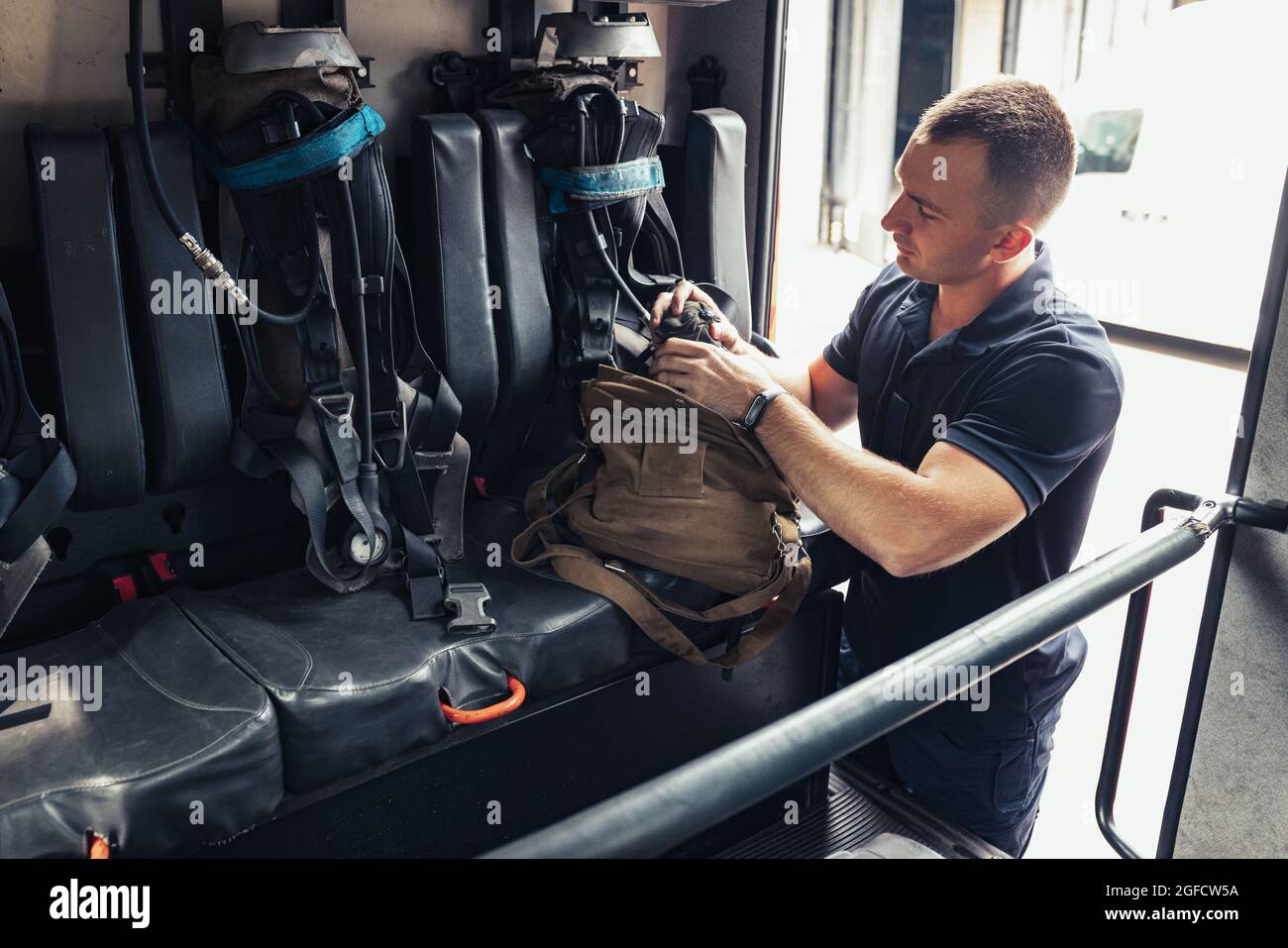 Fireman checking professional firefighting equipment Stock Photo