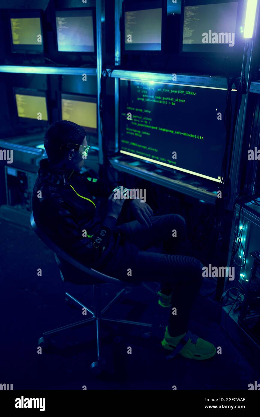 Cyber hacker breaks into databases to obtain information using a computer. Cybercrime and data security concept. Stock Photo