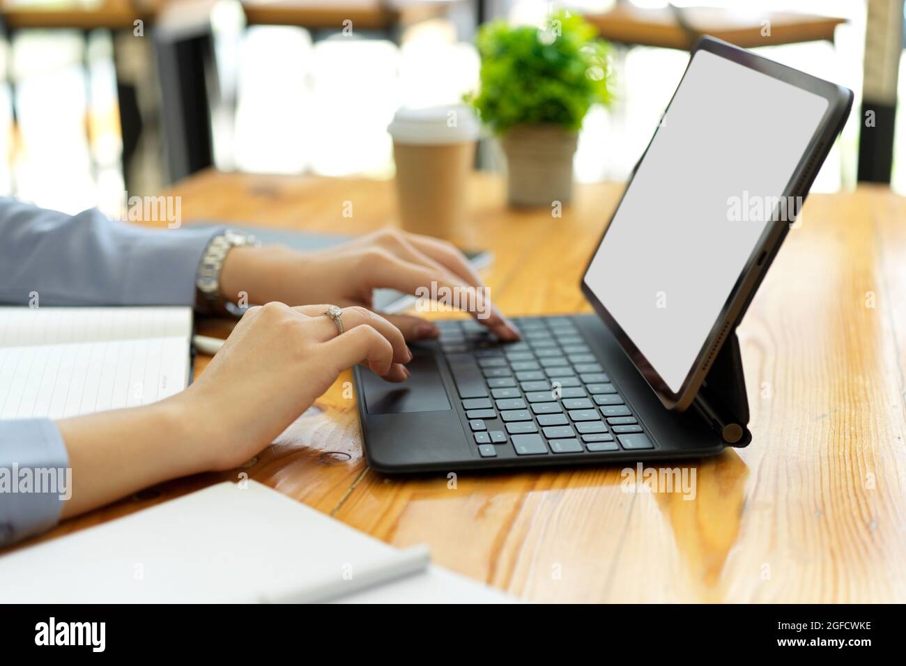 Closeup hands, businesswoman typing on portable tablet keyboard, tablet ...
