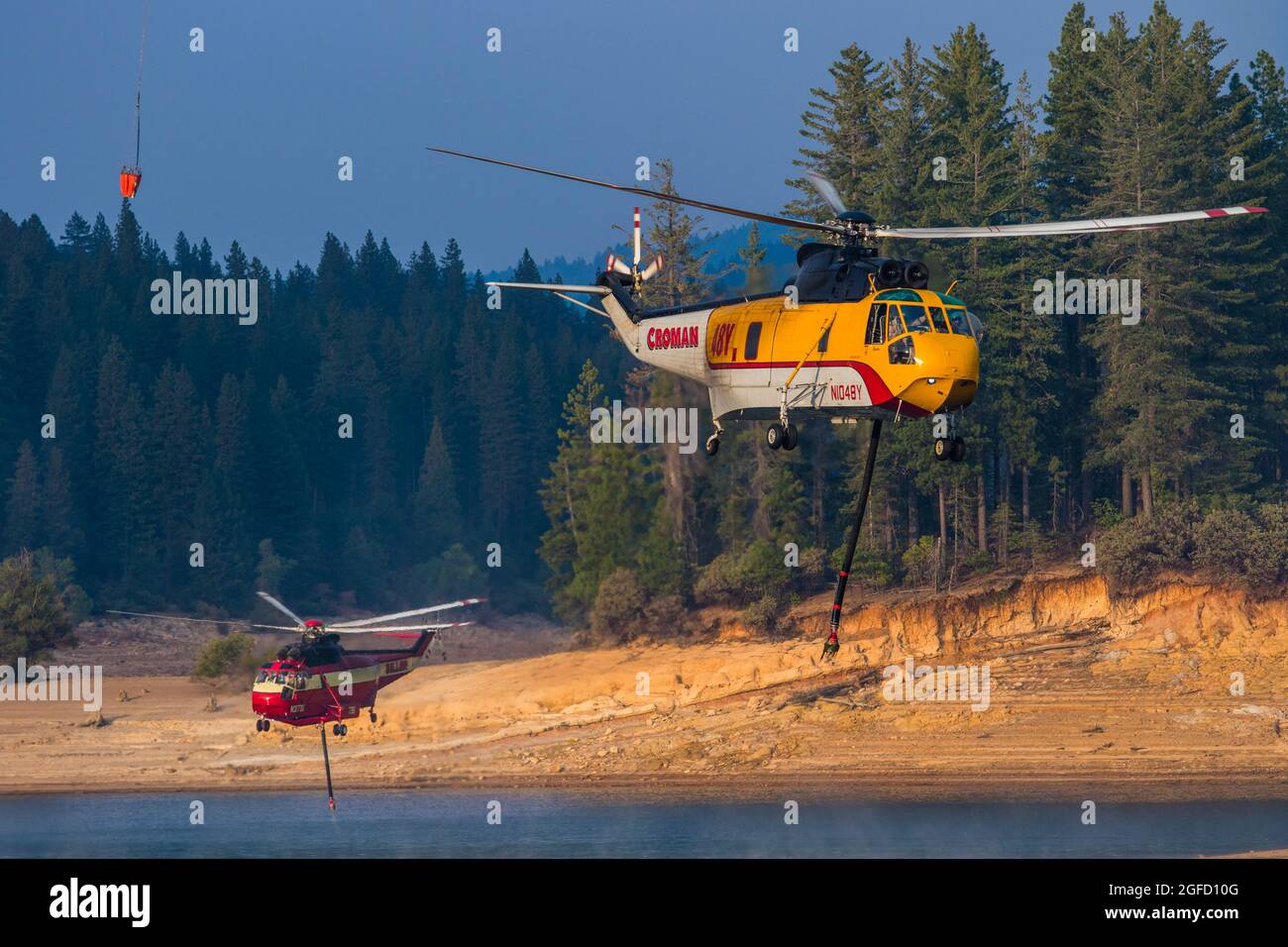 Pollock Pines, United States. 23rd Aug, 2021. Two helicopters take off