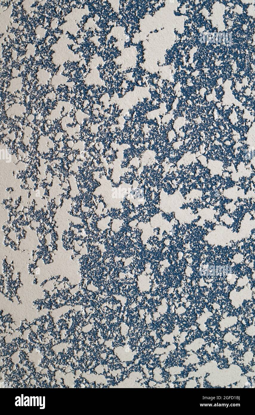 White and blue Textured putty on the wall. Abstract relief background with copy space. Stock Photo