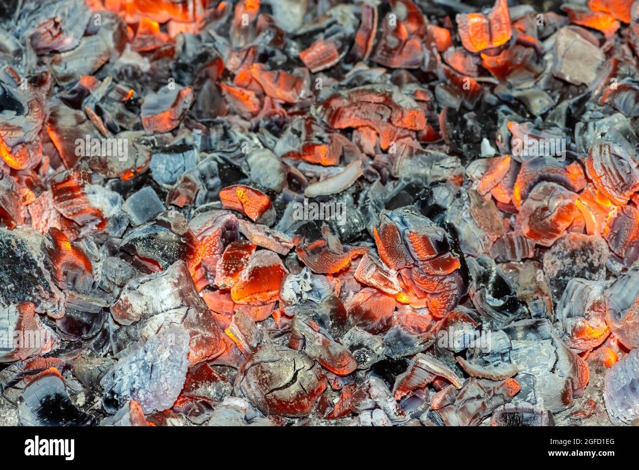 Background of red and black coals close-up for design. Stock Photo