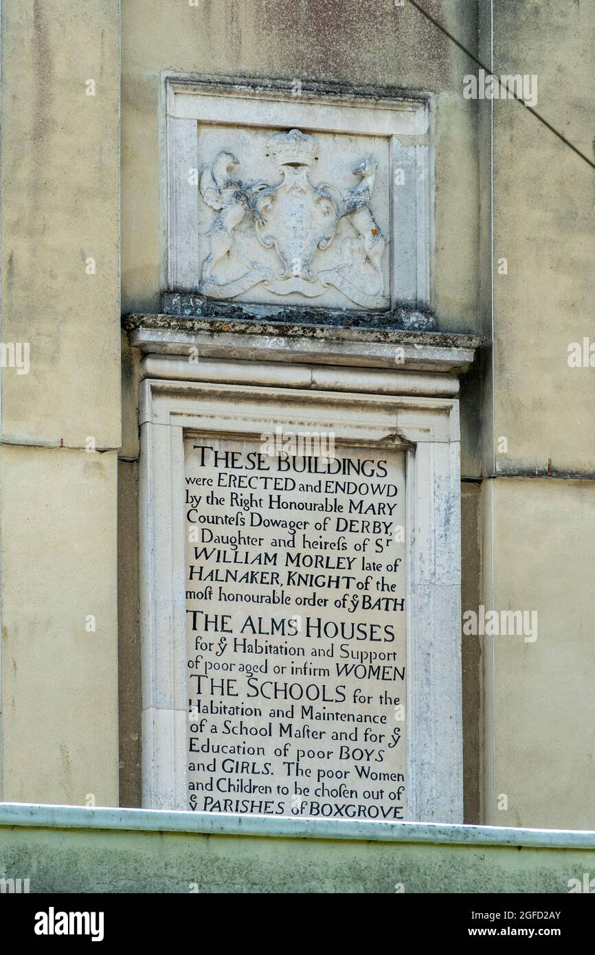 Tthe Countess of Derby's Almshouses in Boxgrove village, West Sussex, England, UK. The centrepiece and inscription on the Grade II listed building. Stock Photo