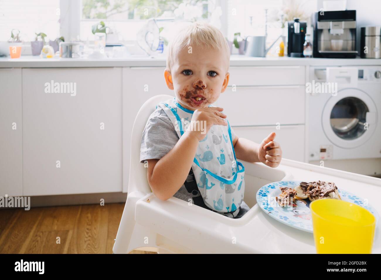 Adorable toddler with face covered in chocolate Stock Photo