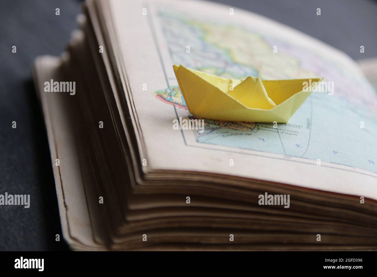 Paper boat on vintage map Stock Photo