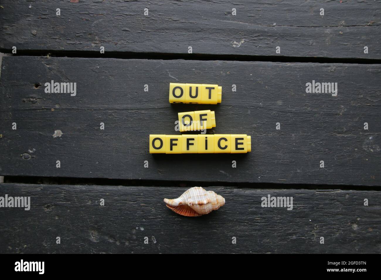 Out of office. High quality photo. Lettering made from yellow cubes. Stock Photo