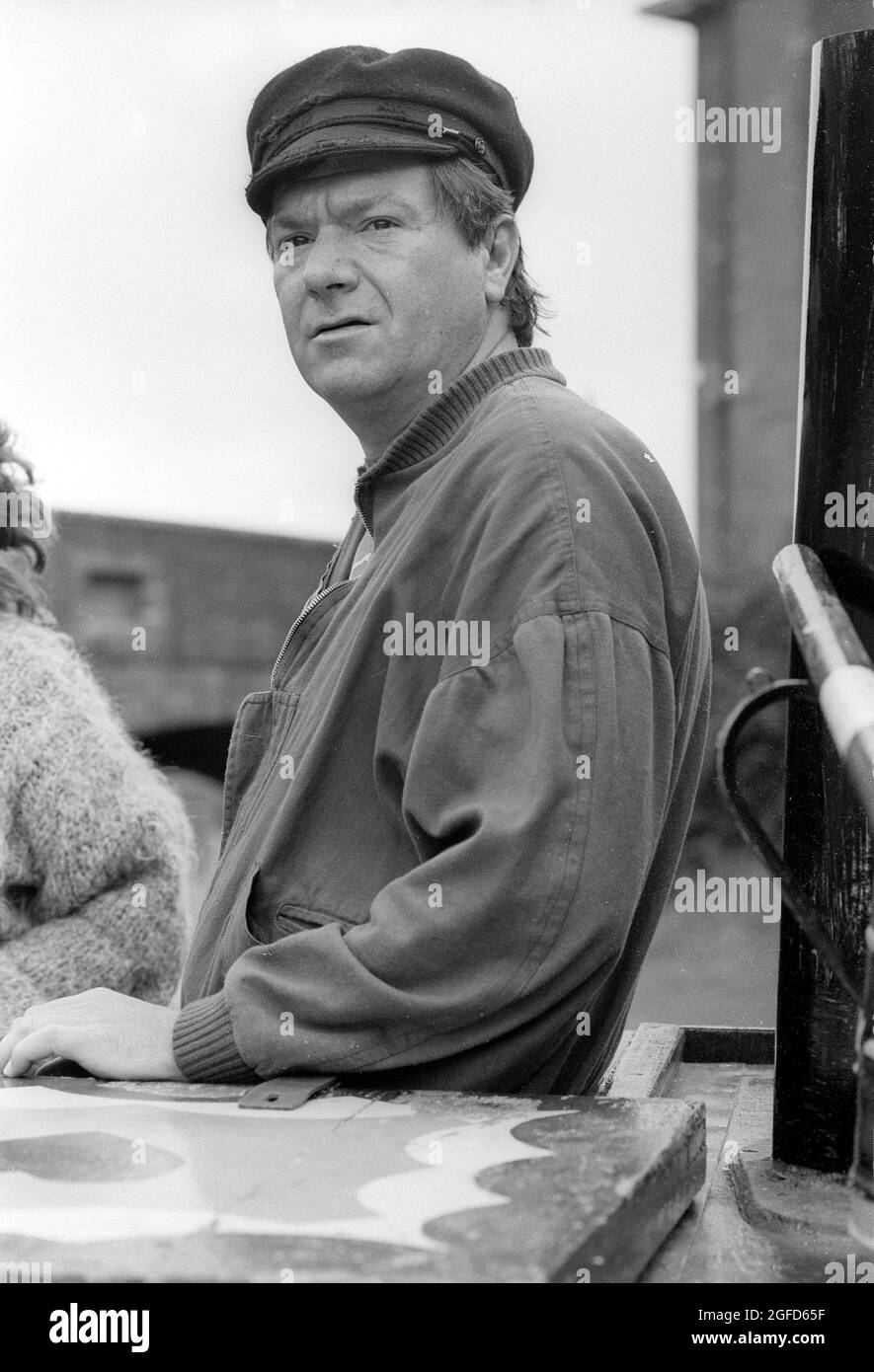 'Cap'n' Michael: actor Michael Elphick as BOON the leading character for the Central TV series BOON in 1985 takes time of from filming to enjoy the life on narrow boat canal craft as he learns to navigate the craft through the Birmingham canal system. Stock Photo
