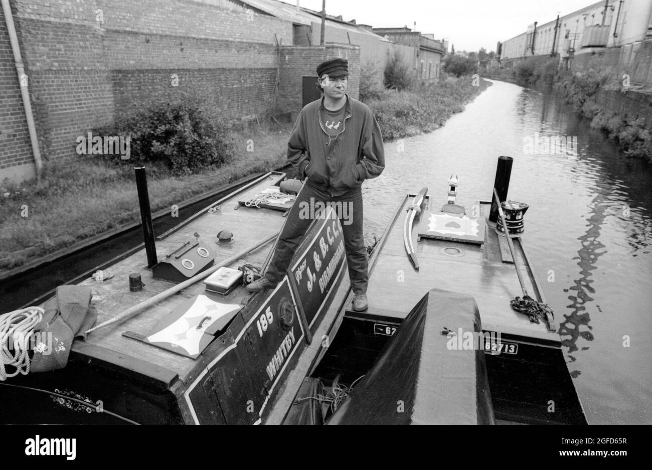 Astride two narrow boats in the Birmingham canals actor Michael Elphick as BOON the leading character for the Central TV series BOON in 1985 takes time of from filming to enjoy the life on canal craft. Stock Photo