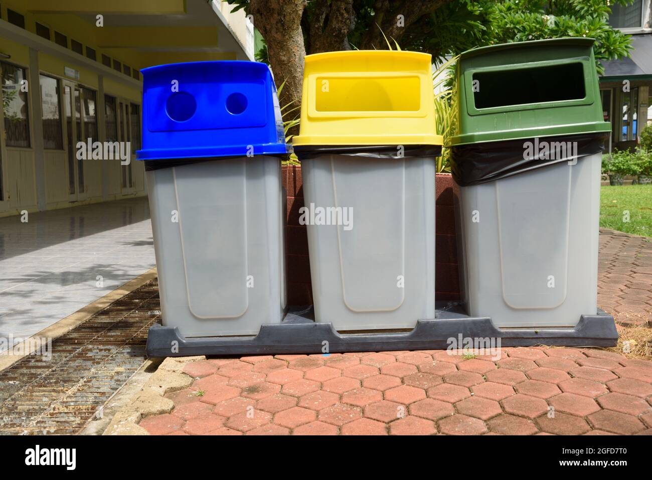 Garbage bins separated by colors foe recycling, glass and general waste