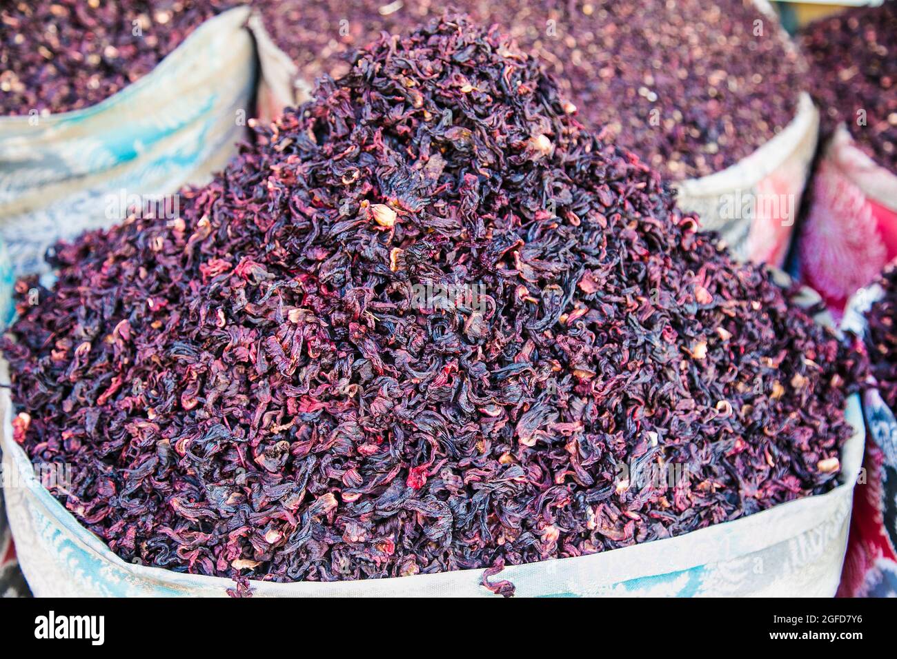 Dry karkade tea leaves in the wicker basket on the street market. Hurgada. Egypt. Dry herb hibiscus for tea in baskets. Arabic herbs on traditional ba Stock Photo