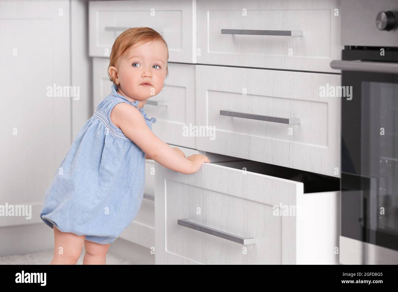 Child playing with cupboard Stock Photo Alamy
