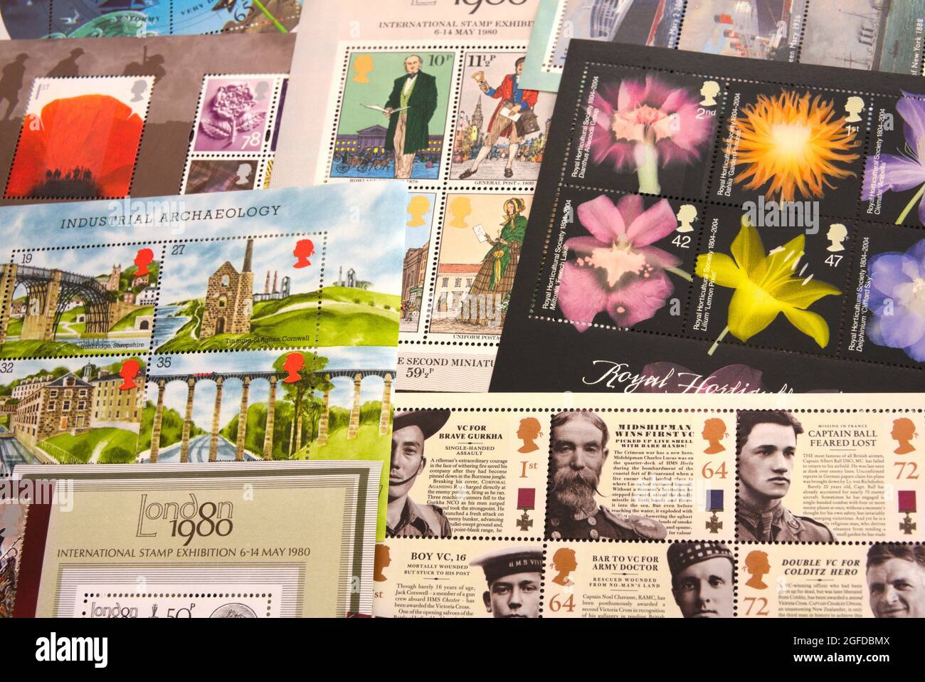 A group or collection of Royal Mail mini sheets of commemorative postage stamps, used to send or