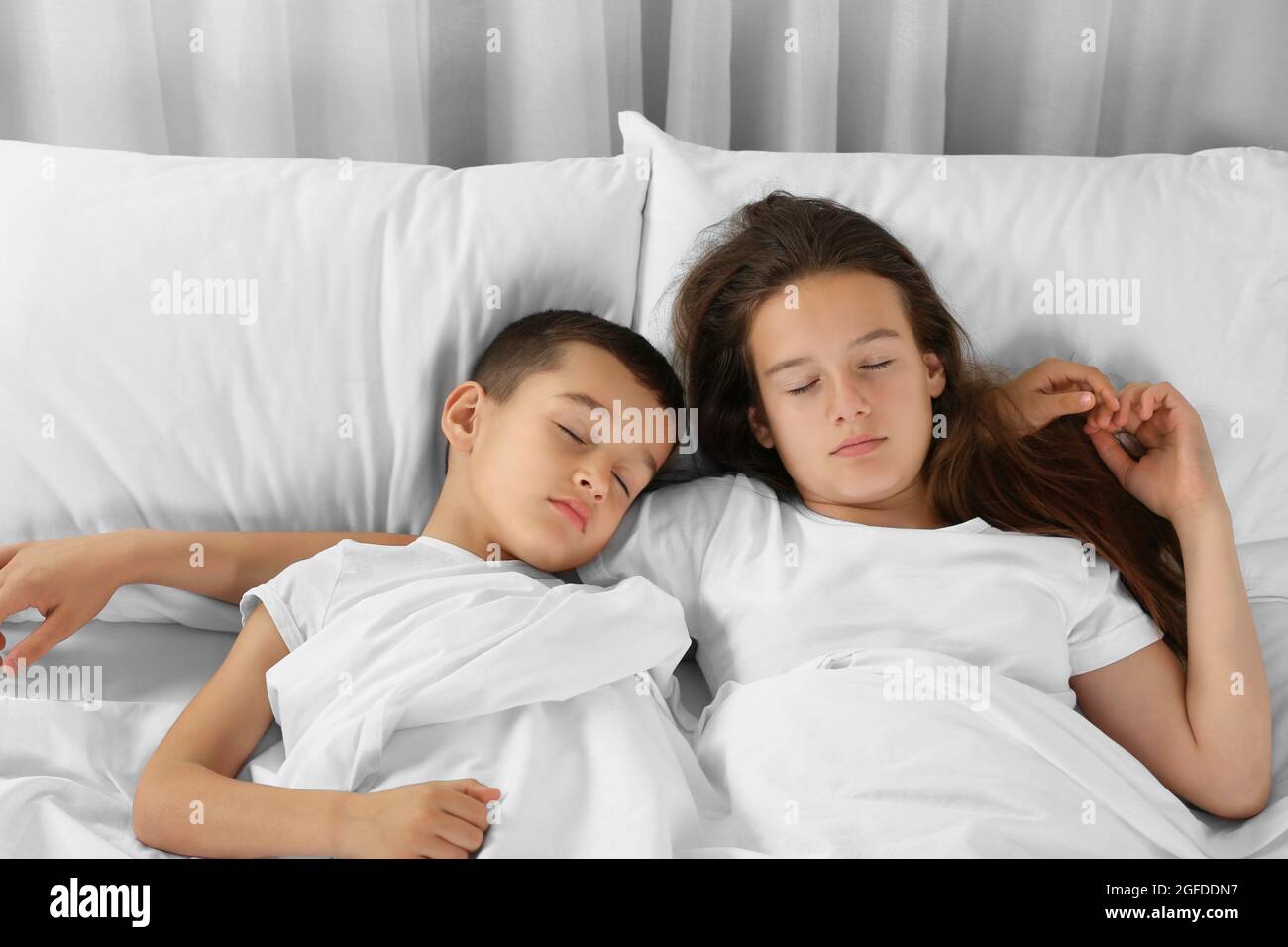 Brother and sister sleeping in bed Stock Photo image photo