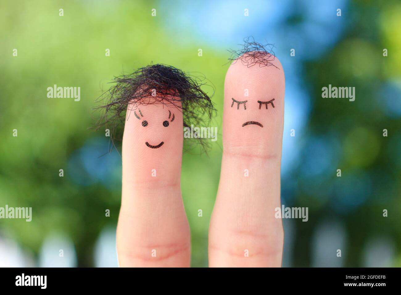 Fingers art of people. One woman is upset because she doesn't have much hair. Stock Photo