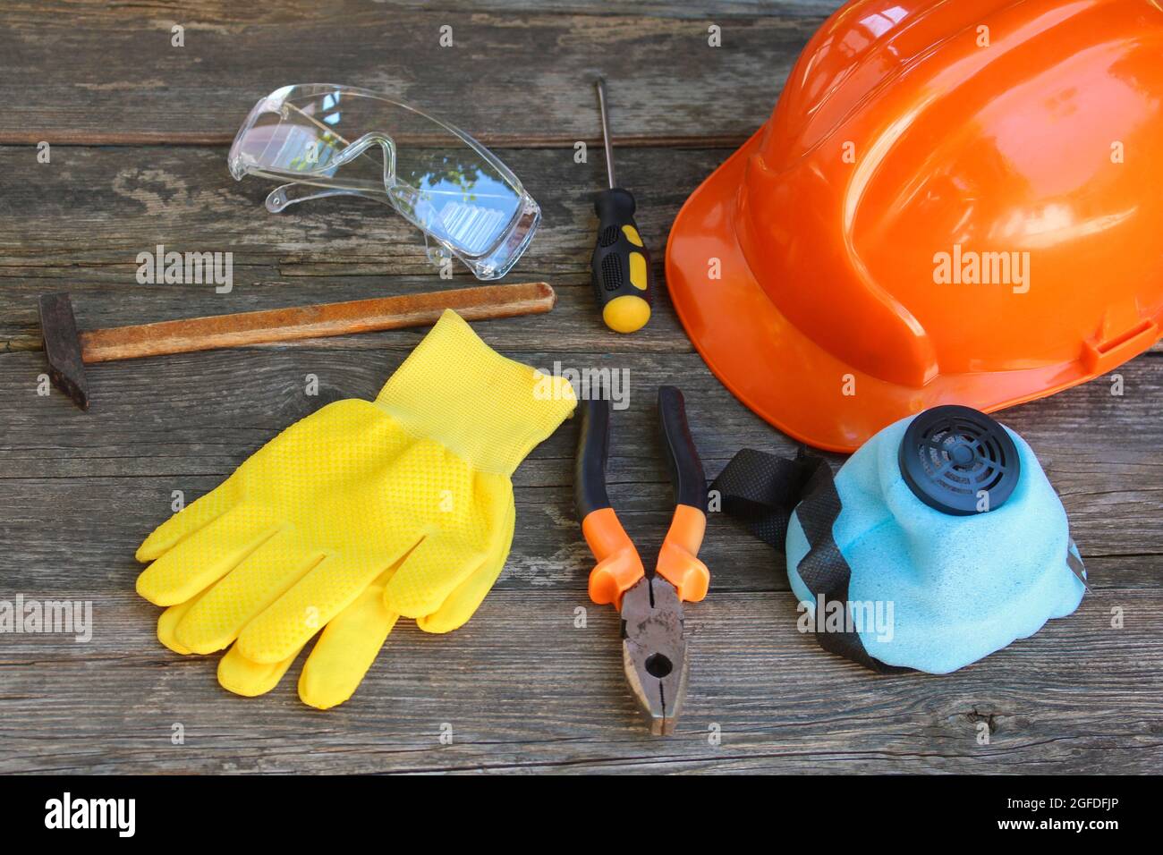 Construction tools and means of protection on an old wooden background. Stock Photo
