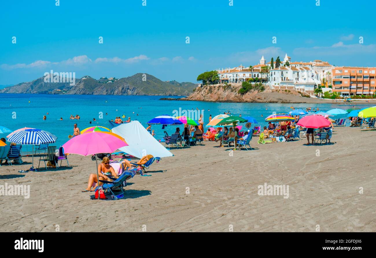 Aguilas, Spain - July 27, 2021: Some people are enjoying the beach in Calabardina Beach, in Aguilas, in the Costa Calida coast, Murcia, Spain Stock Photo