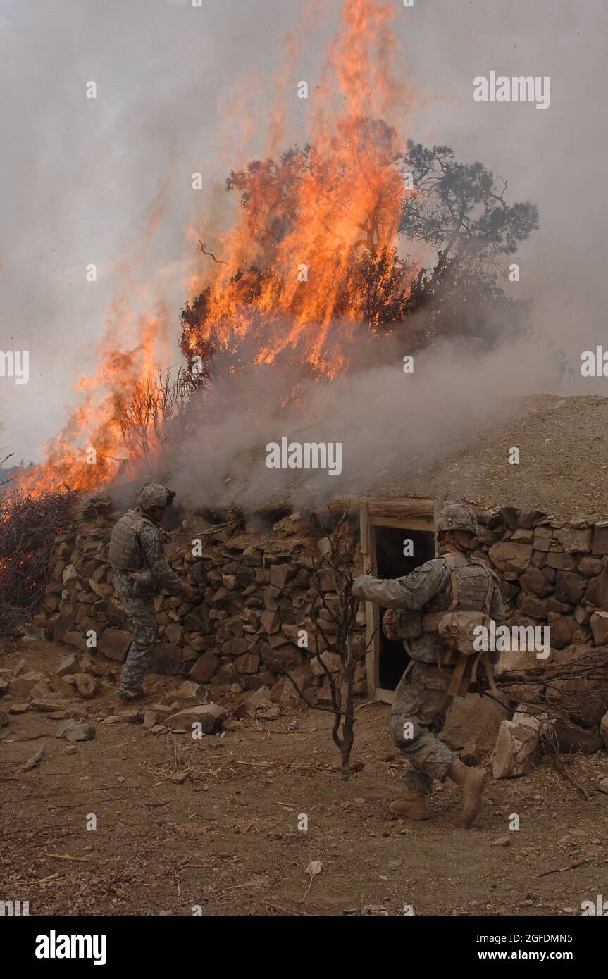 Soldiers from Charlie Company 2/87 burn down a Taliban Safe House discovered during Operation Catamount Fury, a battalion size mission taking place in the Paktika Province of Afghanistan on March 30, 2007 that is focused on limiting the movement of the Taliban within Paktika. U.S. Army photo by: SSG Justin Holley, 982 Combat Camera Company.  (Released) Stock Photo