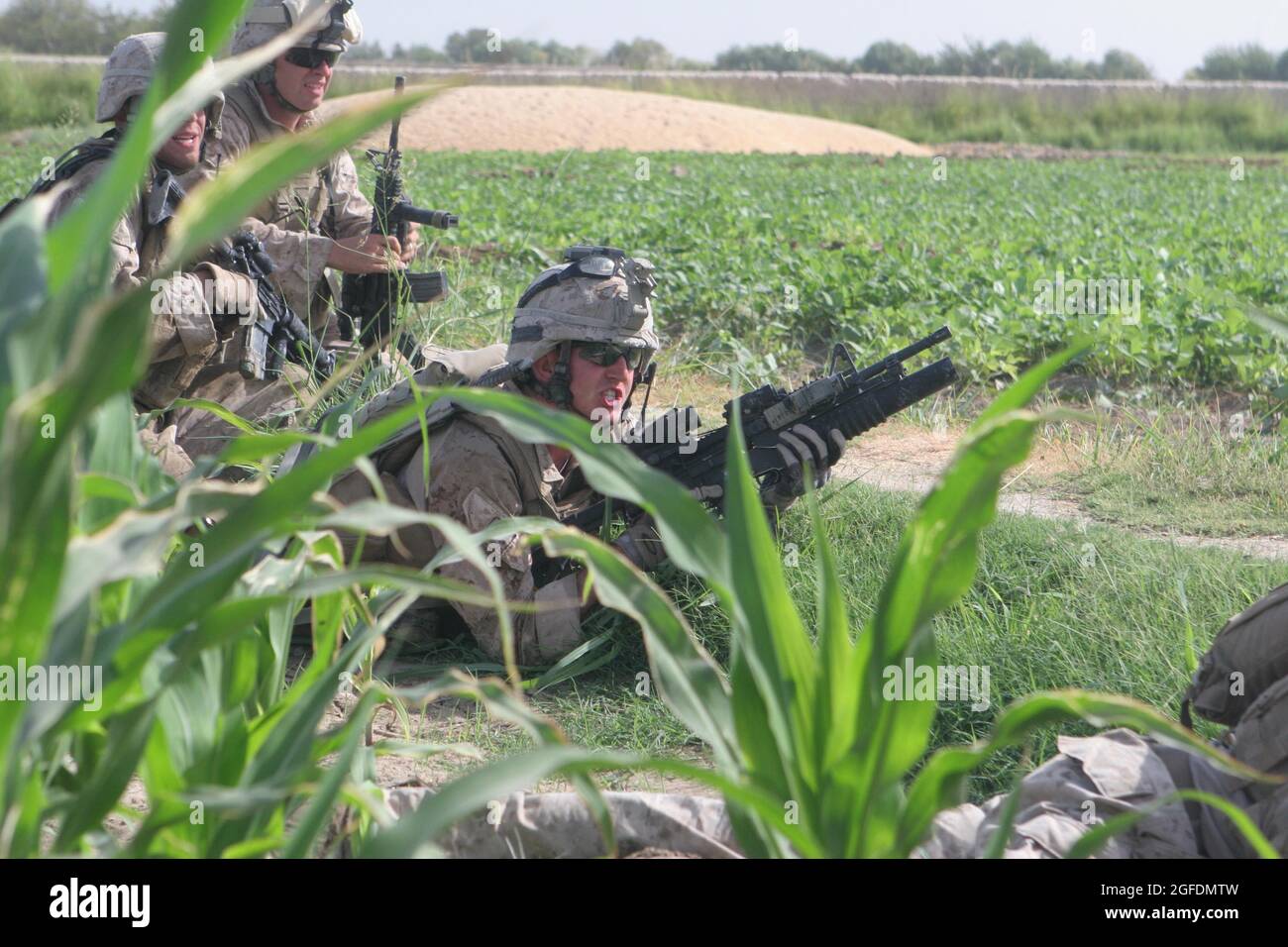 Lance Cpl. Joshua Vance, a team leader with Marines Company E, 2nd Battalion, 8th Marine Regiment, engages enemy positions with his M203 grenade launcher during a six-hour firefight with Taliban insurgents here Aug. 13.  Vance is from Raleigh, N.C. Stock Photo