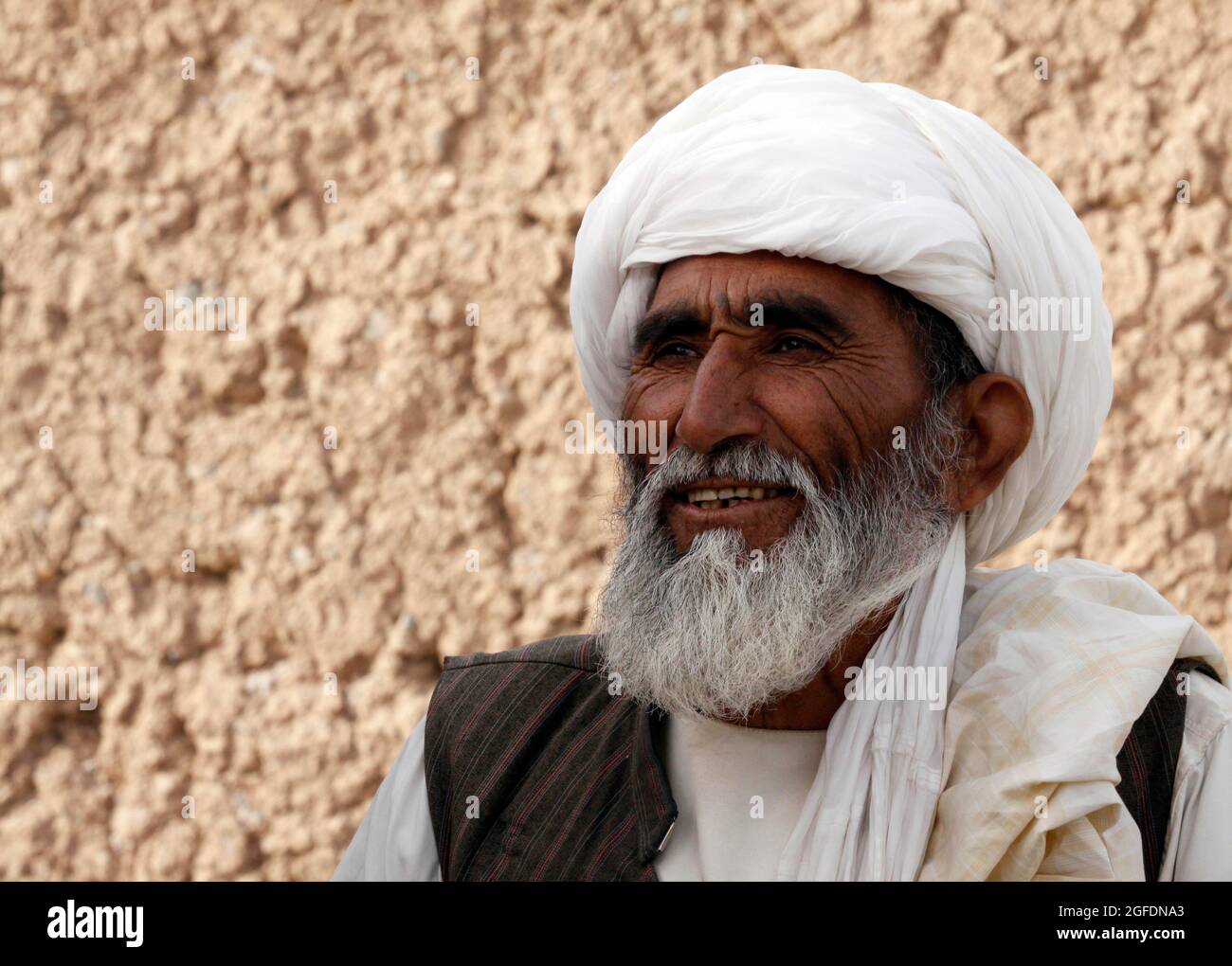 A village elder from the Five Points area smiles as he speaks with Marines of Charlie Company, 1st Battalion, 3rd Marine Regiment during their first meeting Feb. 14.  The man said he was glad to have Marines and Afghan forces in the area to help with security and drive out the Taliban.  Marines had been previously unable to meet with local leaders due to engagements with Taliban fighters during their patrols. Stock Photo