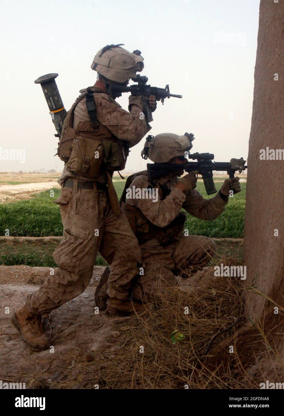 Lance Cpls. Robert J. Martin and Matthew W. Urbaniak, both with Combined Anti-Armor Team 1, Weapons Company, 1st Battalion, 3rd Marine Regiment, fire back on Taliban fighters who engaged their patrol in the Five Points area Feb. 14.  They were fired upon by the Taliban only minutes after the first meeting between Marines and village elders.  Martin, 25, is from Easton, Pa., and Urbaniak, 21, is from Bel Air, Md. Stock Photo