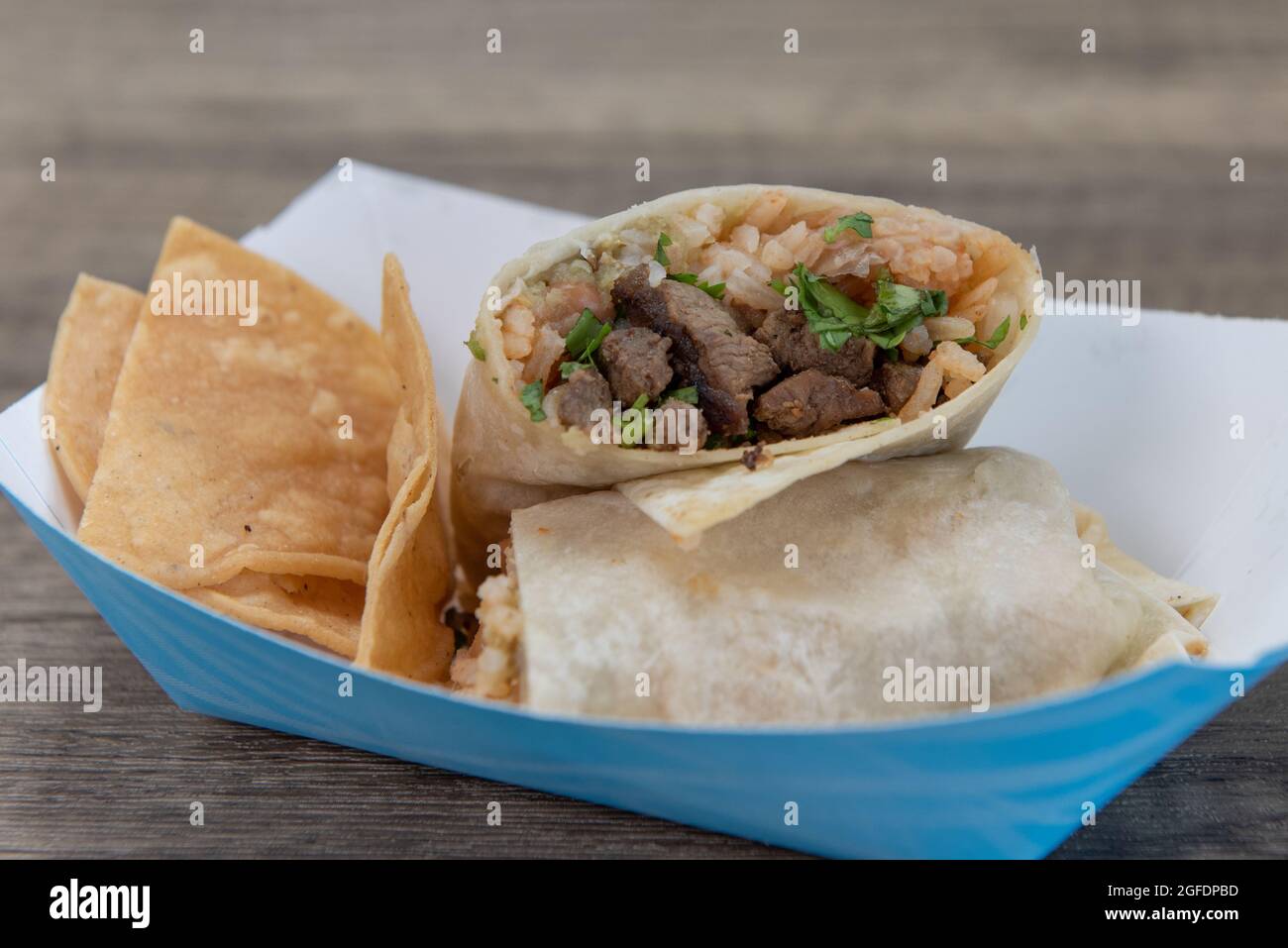 Hearty kids size burrito filled with rice, beans, and carne asada steak