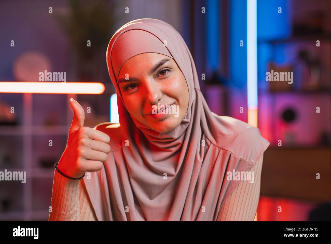 Close up of charming smiling likable young arabian woman in hijab ...