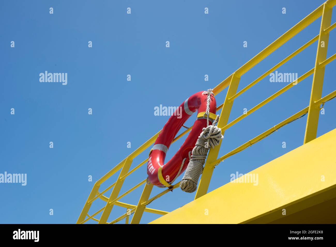 A lifebuoy ring with rope at the back of ferry boat - Travel and shipping safety background Stock Photo