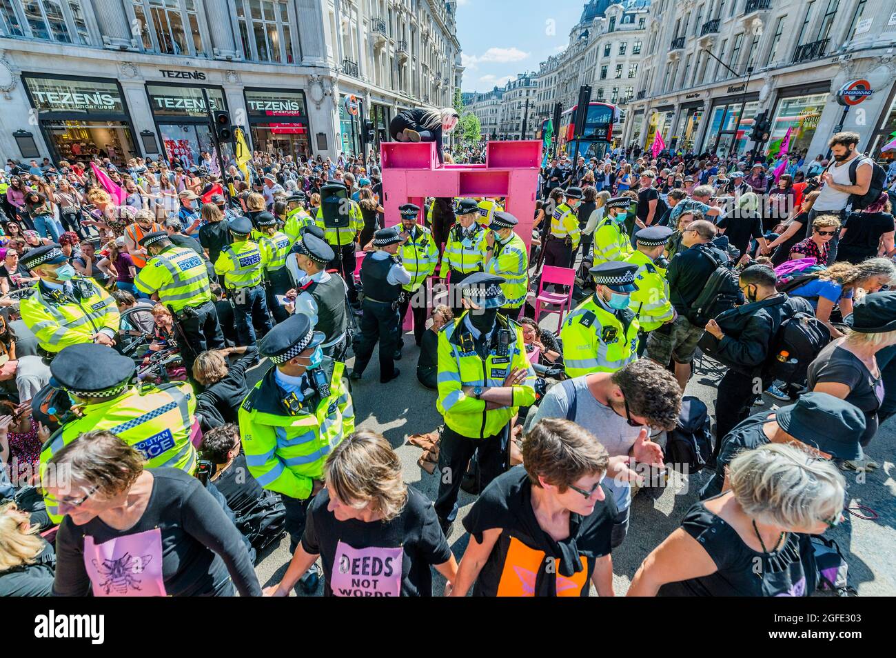 London, UK. 25th Aug, 2021. The police move in aggressively as Rebels occupy Oxford Circus and quickly build a pink structure to block the junction - Extinction Rebellion continues two weeks of protest, under the Impossible Rebellion name, in London. Credit: Guy Bell/Alamy Live News Stock Photo