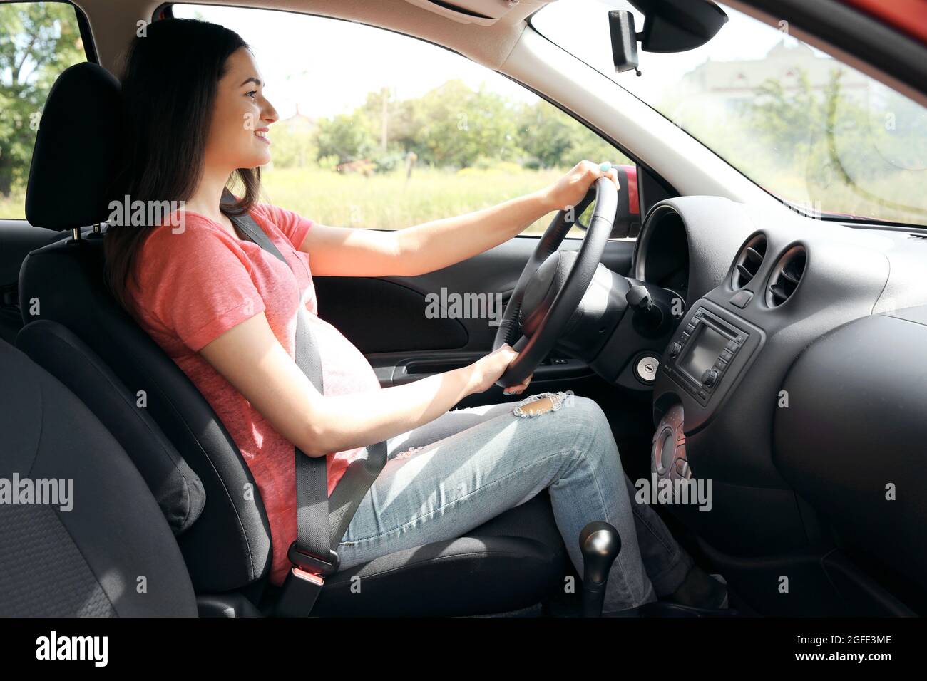 Pregnant woman driving car. Safety drive concept Stock Photo Alamy