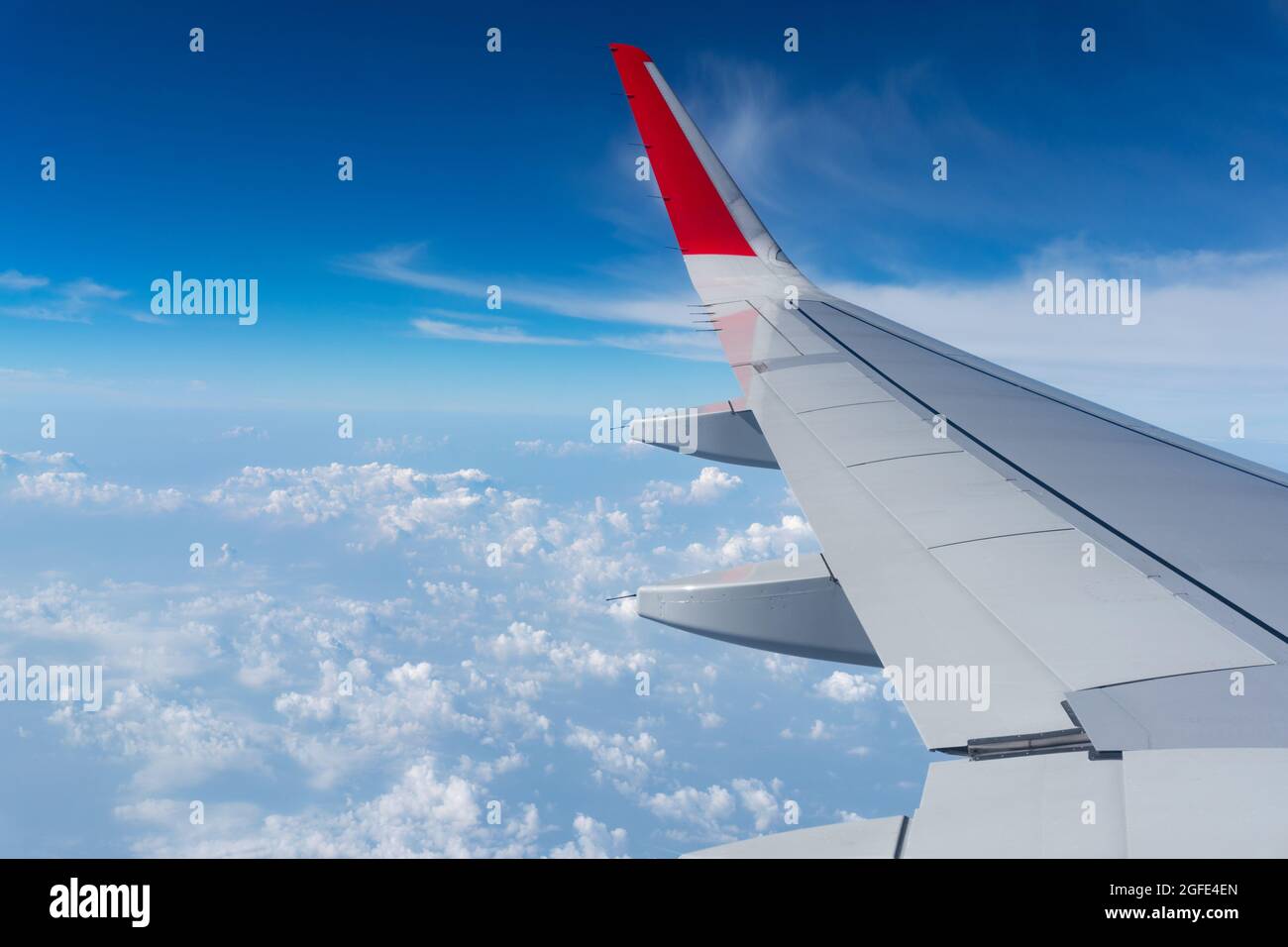 Air Plane wing on the blue sky and clouds can be used for air transport to travel and open season to travel background Summer season concept Stock Photo