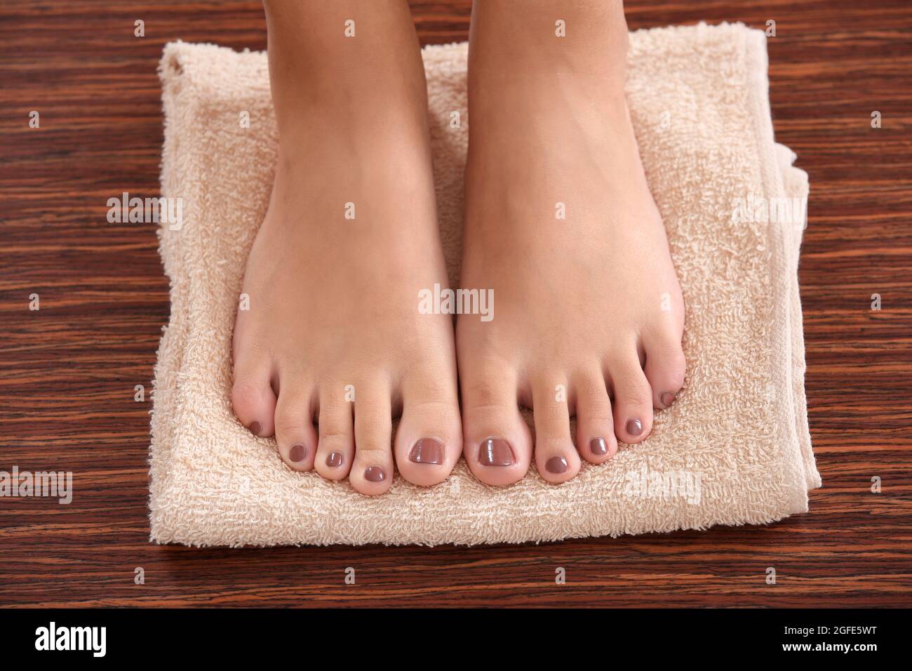 Female feet with brown pedicure on towel, closeup Stock Photo Alamy