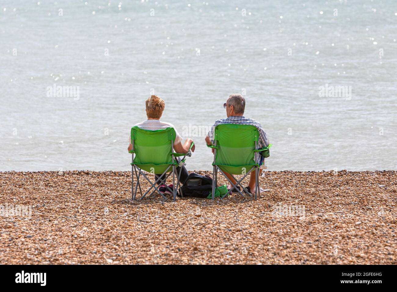 Couple sitting in beach chairs hi-res stock photography and images - Alamy