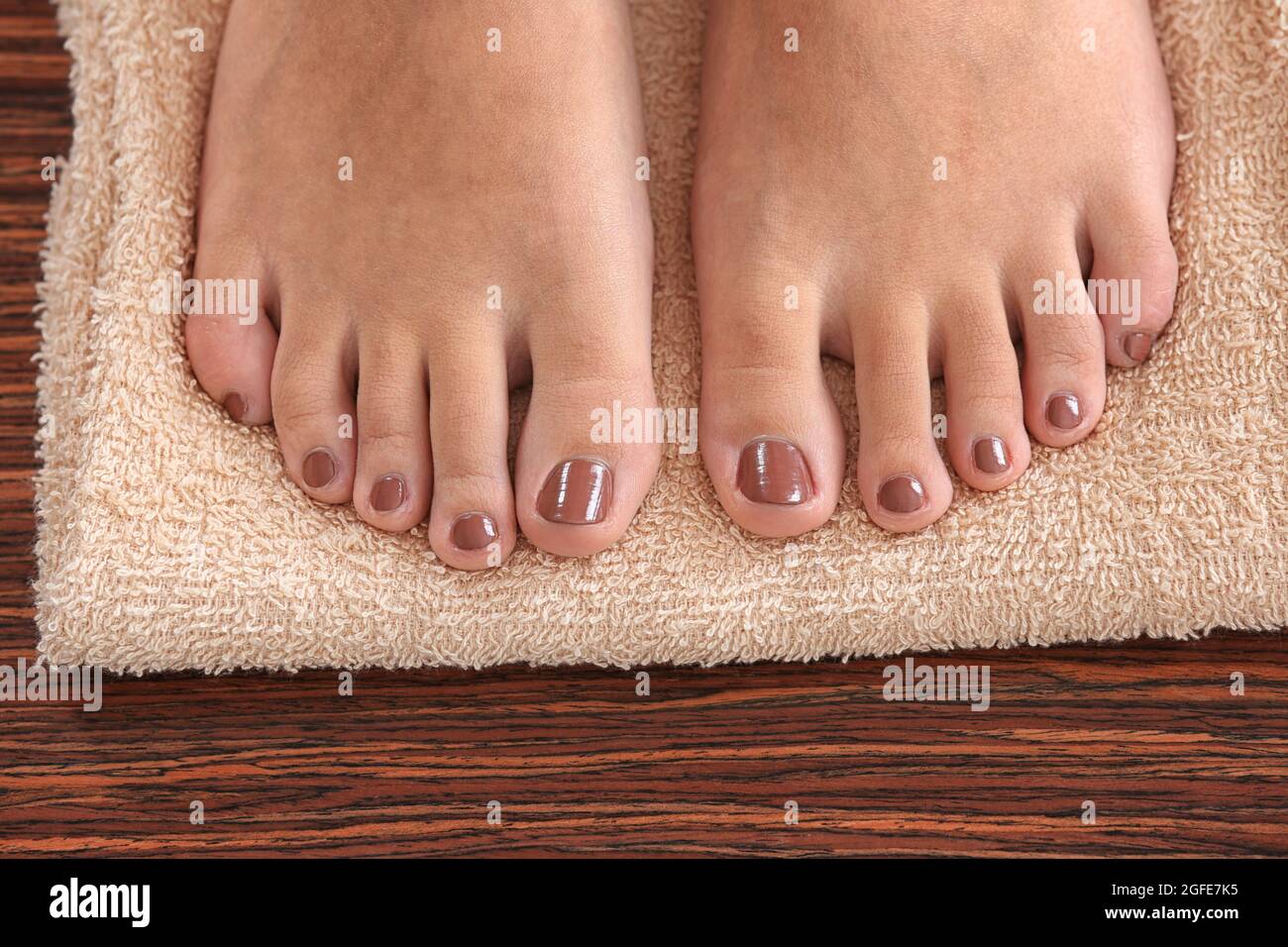 Female feet with brown pedicure on towel, closeup Stock Photo Alamy