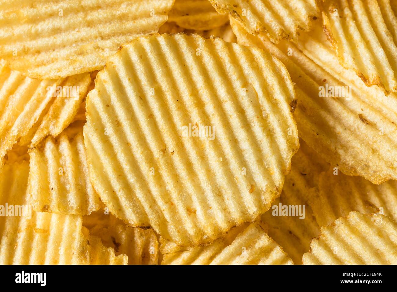 Salty Ruffled Potato Chips in a Bowl Stock Photo