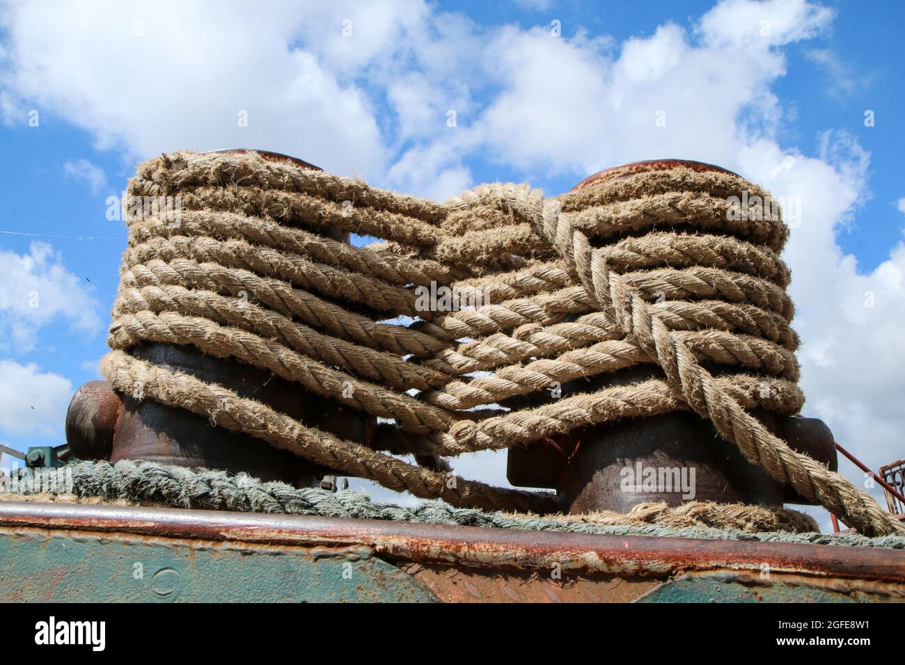 The detail of the marine rope tied to two posts. Symbol for connection or something fixed strong. Stock Photo