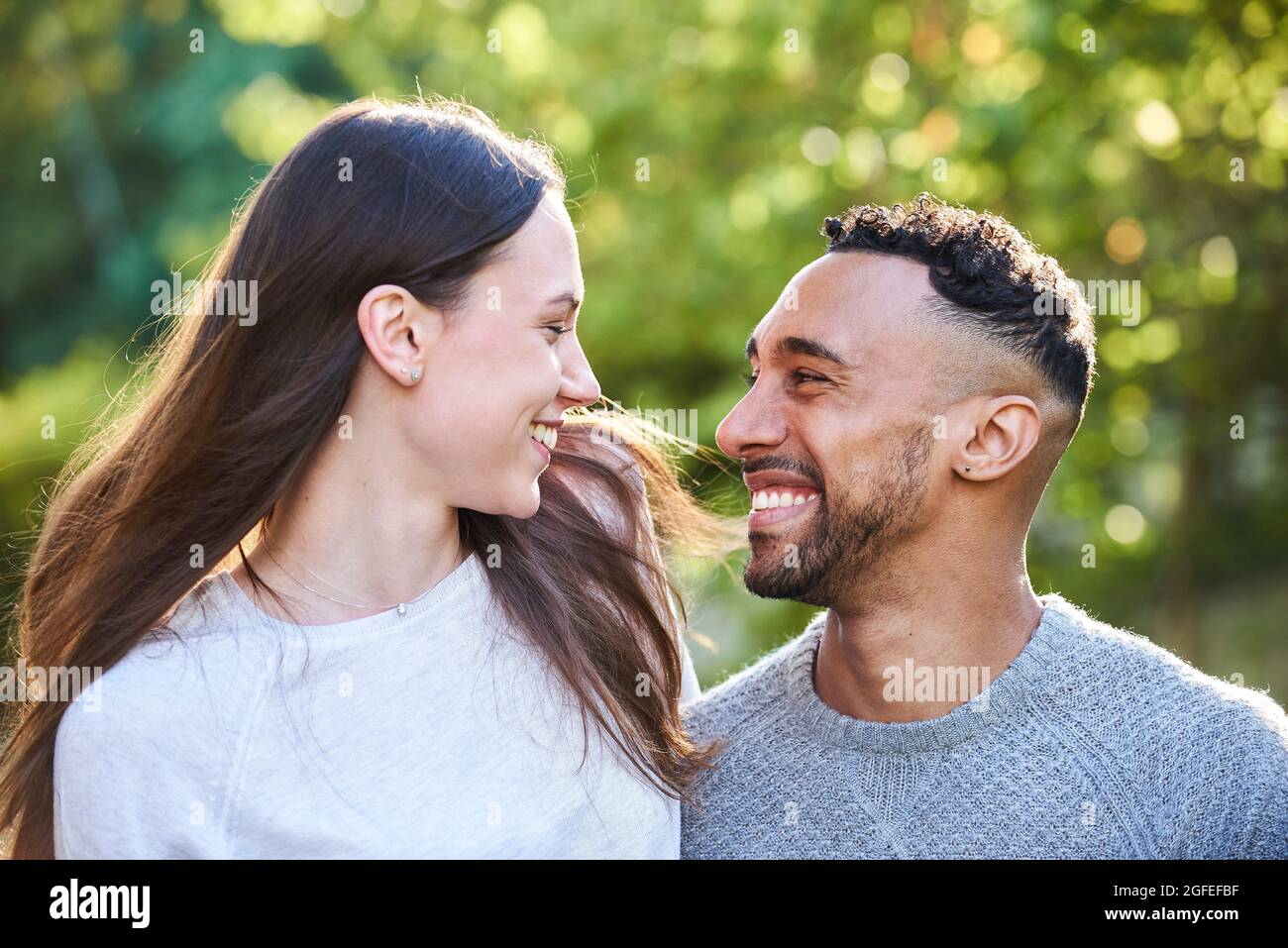 Smiling young couple looking at each other Stock Photo
