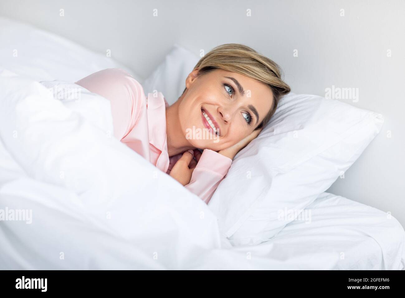 Happy Mature Woman Looking Away After Wake Up Stock Photo - Alamy