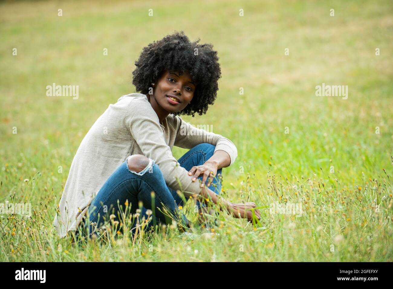 Thoughtful black woman sitting hi-res stock photography and images - Alamy